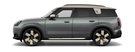 Ein MINI Countryman in einem modernen Grauton mit beigem Dach. Auffällig sind hier die aerodynamischen Felgen mit breiten, hellen Speichen.